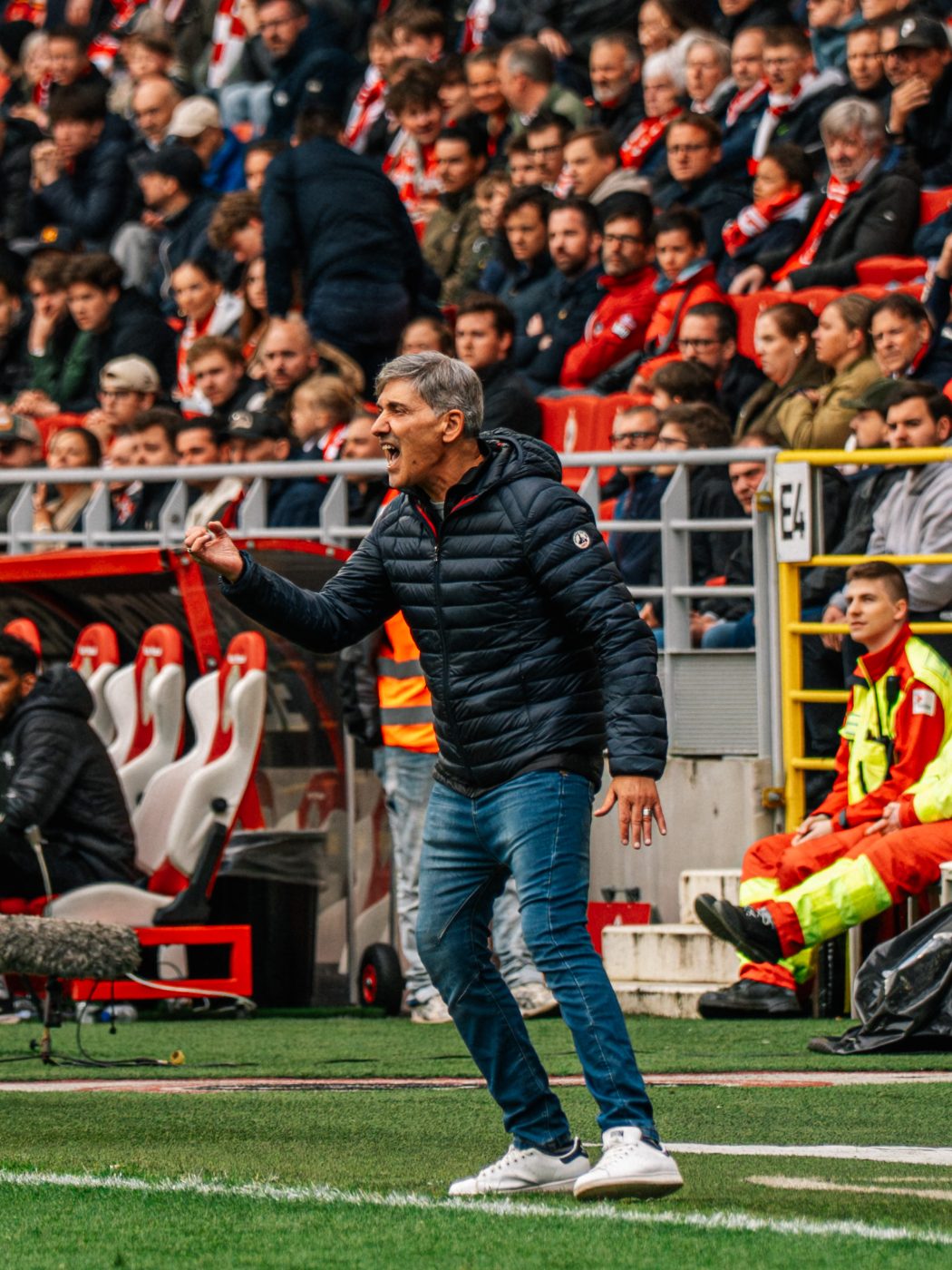 the head coach reading the game from the touchline