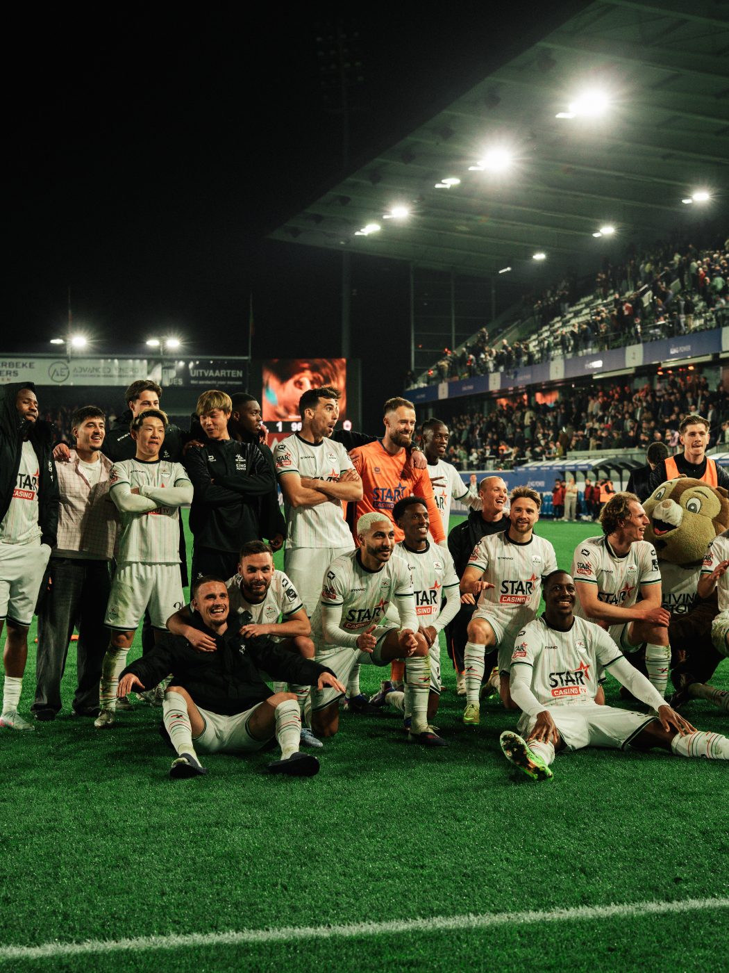 the squad together on the pitch after a win