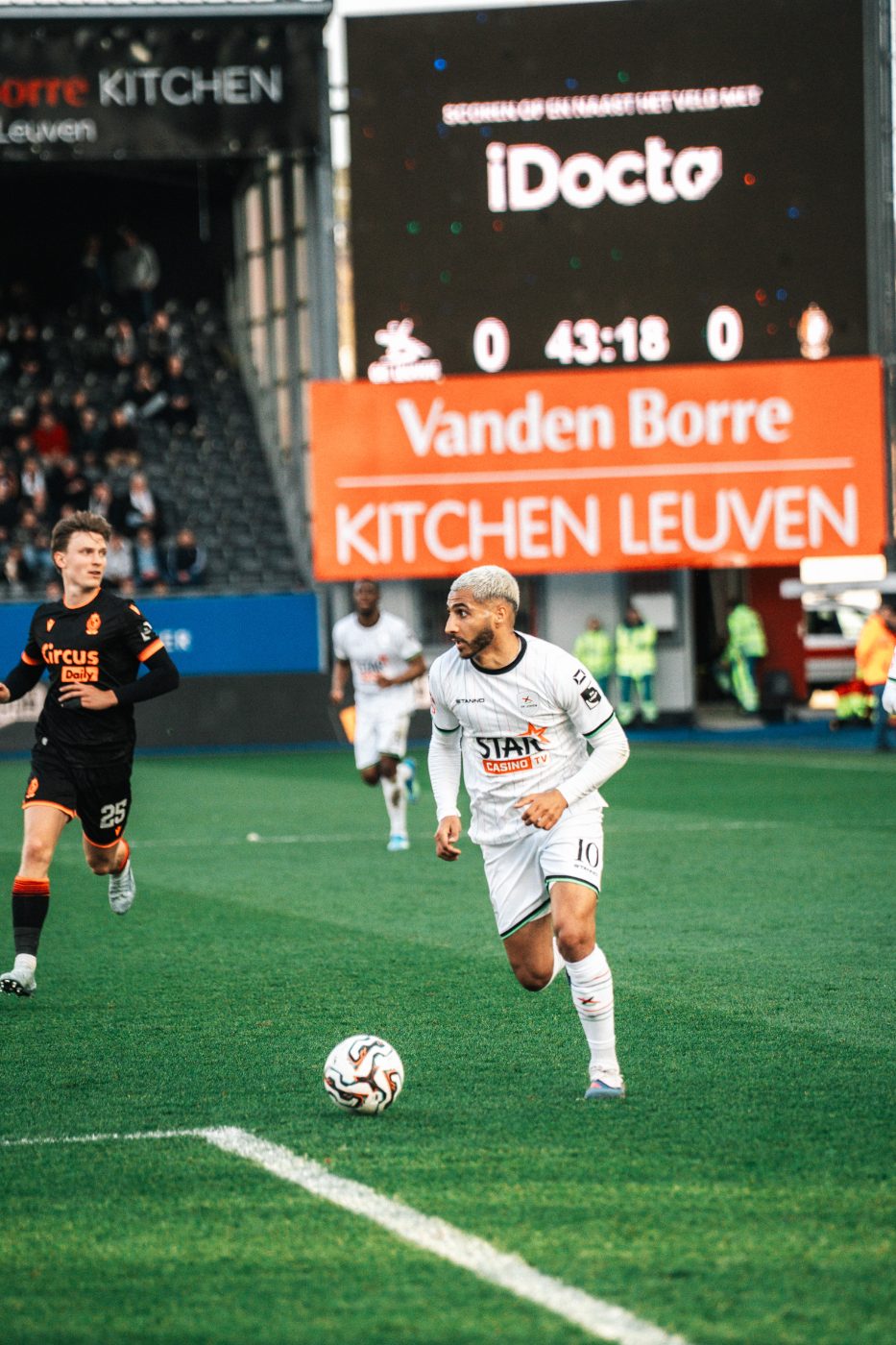 on the ball in front of the scoreboard