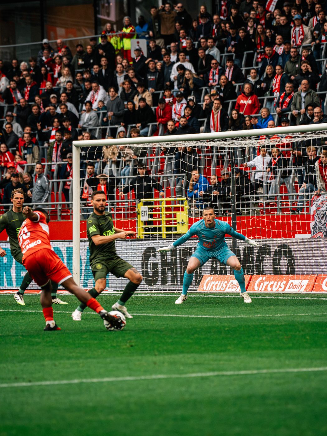 pressing at the far post in front of the crowd