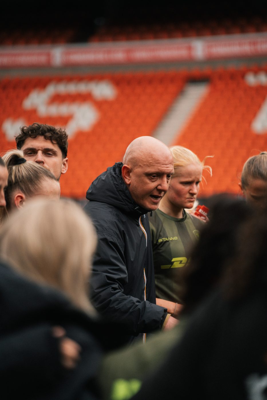 staff in conversation on the sideline